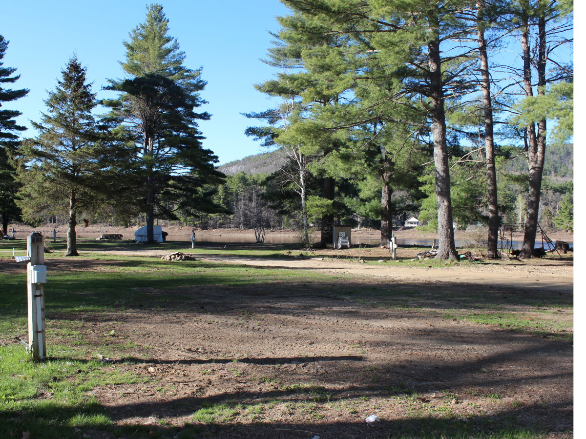 Wide campground landscape, trees, lake, river, or scenic seasonal camping environment.